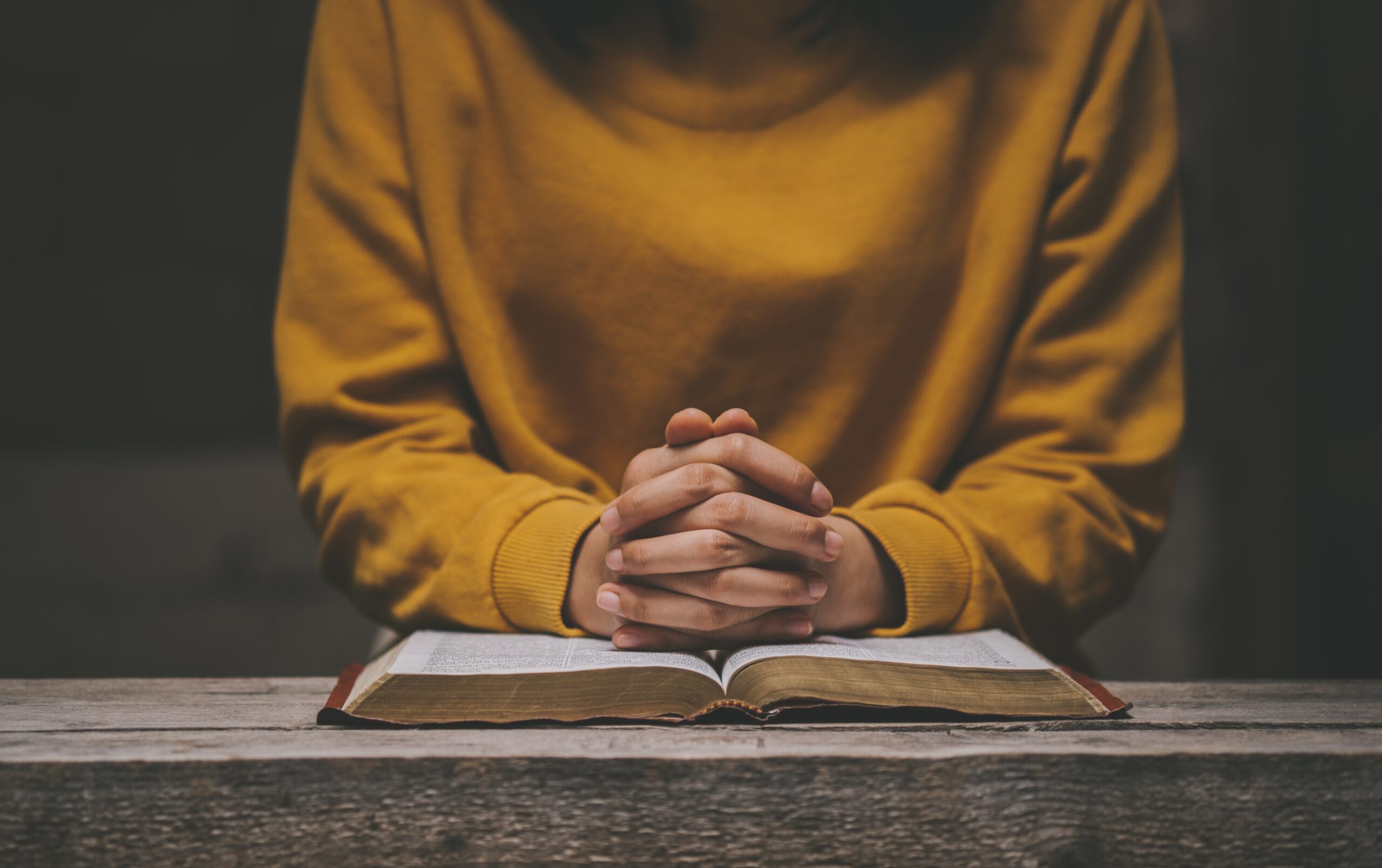 Woman,Praying,On,Holy,Bible,In,The,Morning.,Holding,Hands