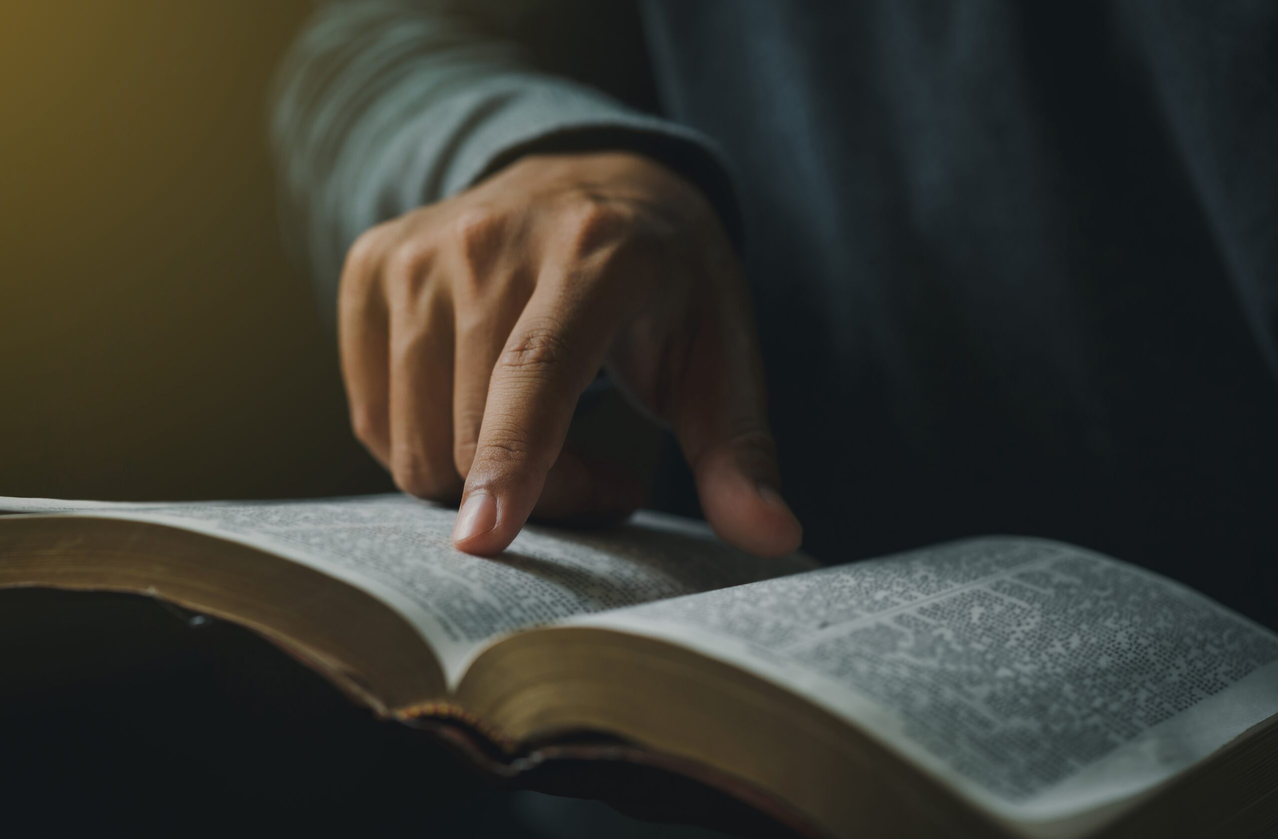 Close-up,Of,Christian,Man’s,Hands,While,Reading,The,Bible,Outside.sunday